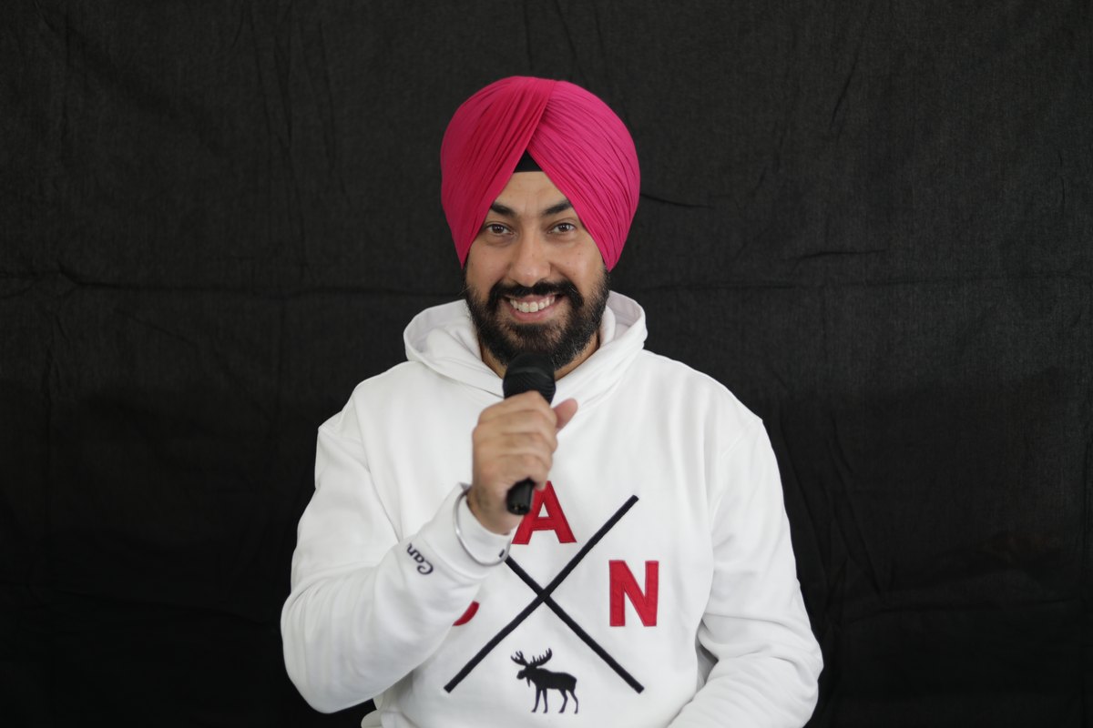 Harmeet Singh Kohli performing stand-up comedy at a corporate gala in Surrey BC