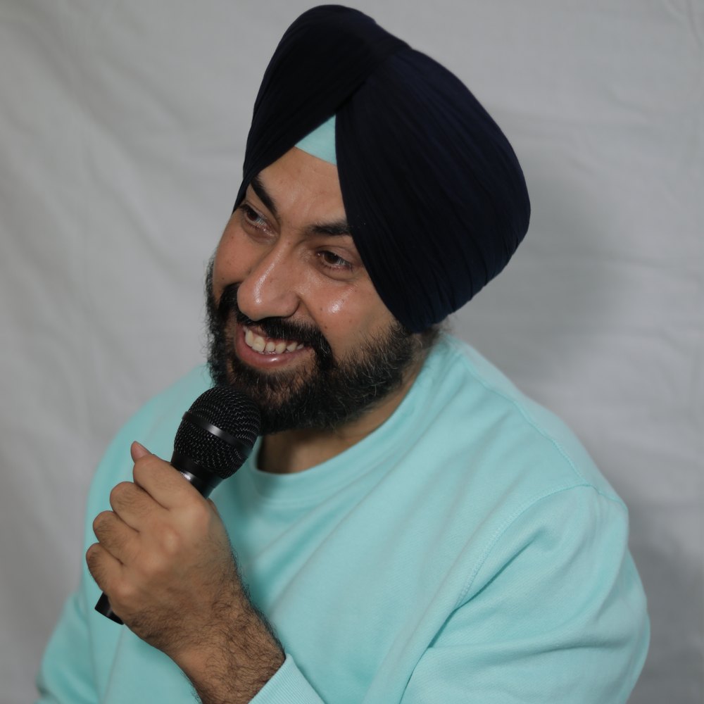 Harmeet Singh Kohli performing stand-up comedy on stage in Vancouver